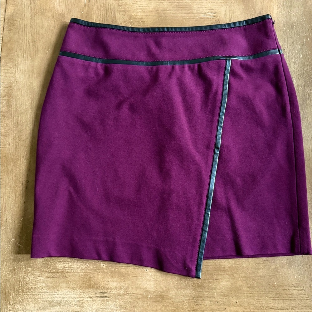 White House Black Market color is plum with faux black leather trim. Size 6.